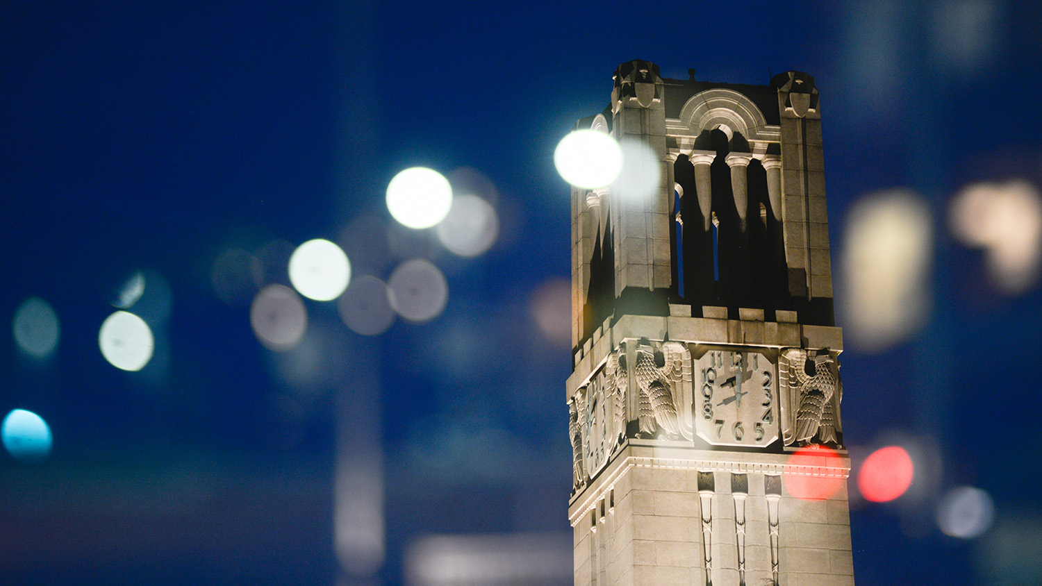 The NC State Belltower at dusk and night.