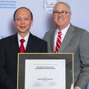 Chancellor Randy Woodson and Vice Provost for International Affairs Bailian Li accept NC State's 2014 Simon Award for Internationalization 