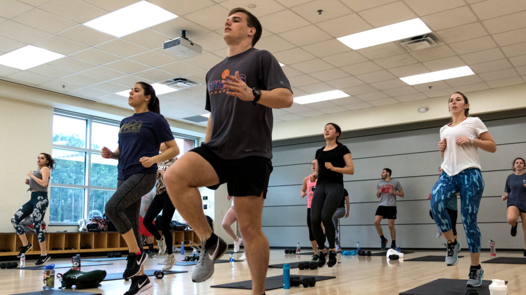 Students exercise in a group fitness class