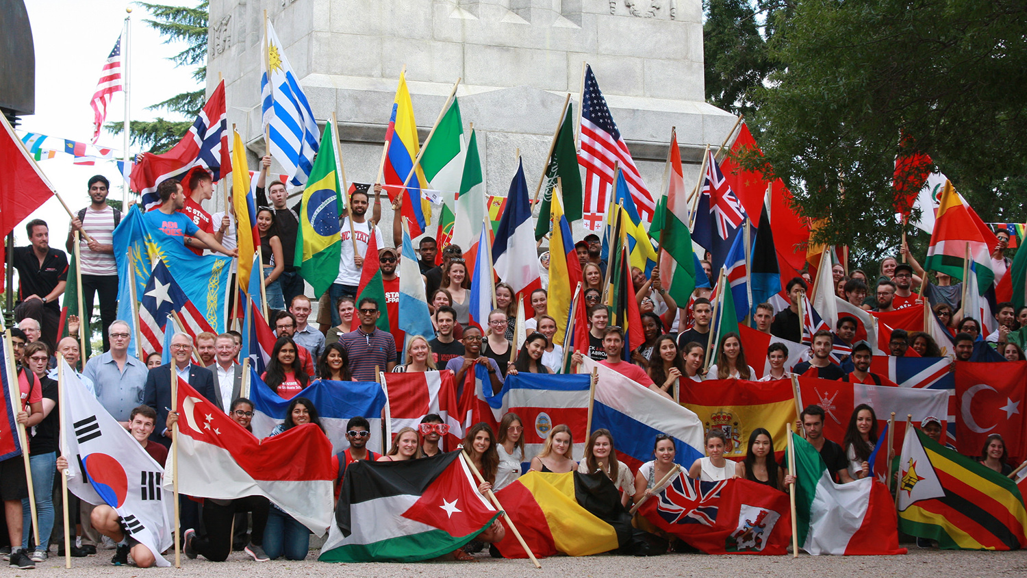 International students with flags at the Memorial Belltower