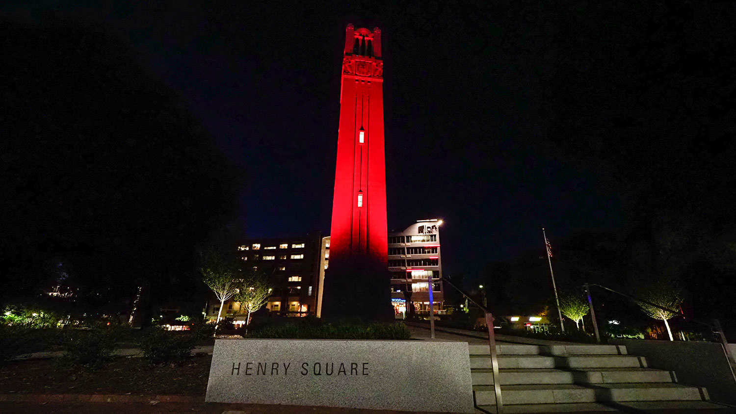 NC State's Memorial Belltower lit red at night