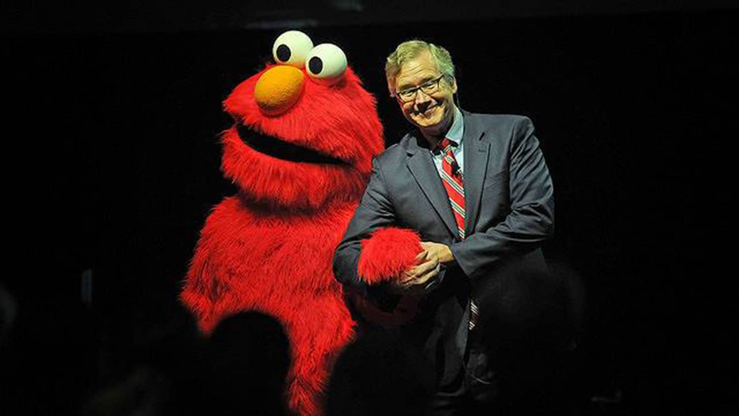 Boney on stage with Sesame Street character Elmo.