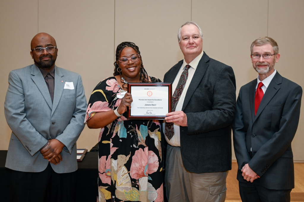 Photo of Jiakaira Dixon with the provost and her supervisor.