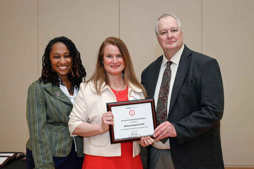 Photo of Melissa Edwards Smith with the provost and her supervisor.