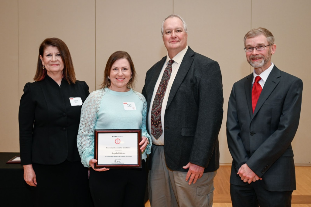 Photo of Angela Hallman with the provost and her supervisor.