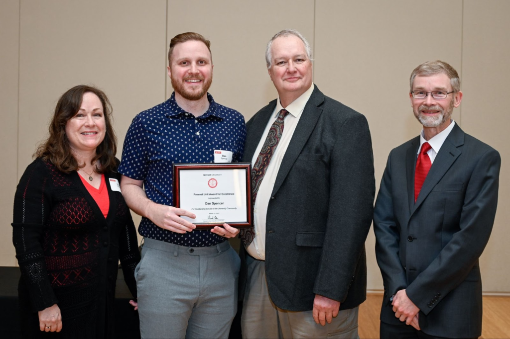 Photo of Dan Spencer with the provost and his supervisor.