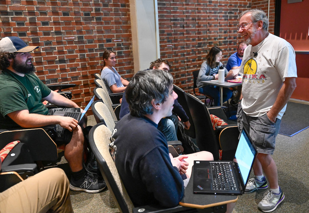 Clyde Sorenson laughs with students