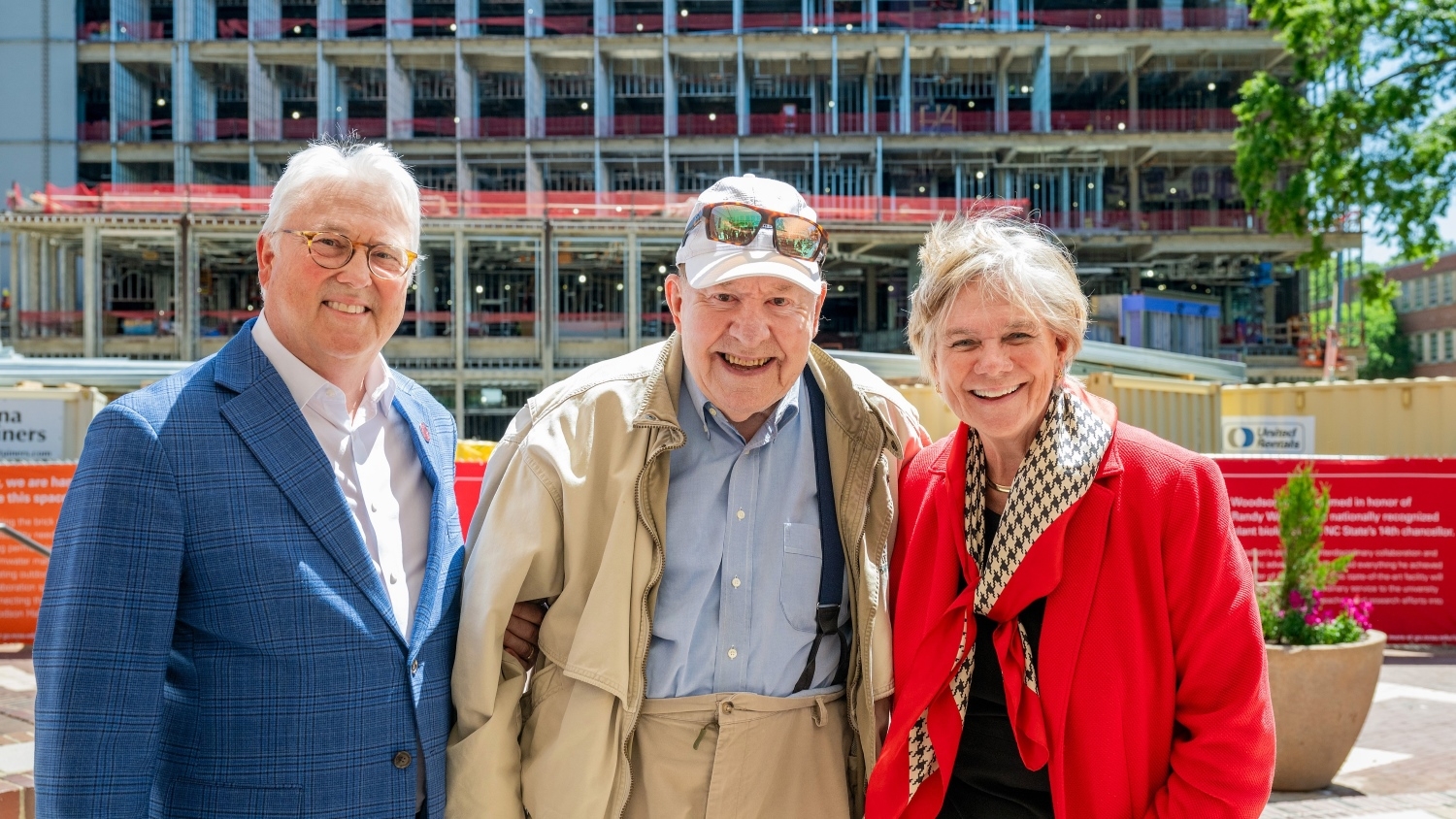 Chancellor Woodson, Tom Kenan, and Nancy Cable posing in front of the Woodson Hall construction site