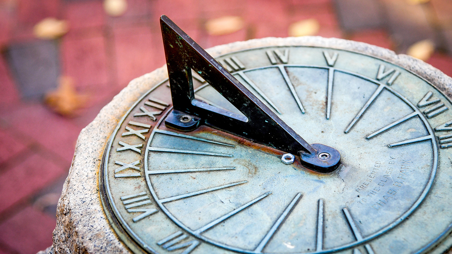 Fall leaves scatter around the sundial outside Primrose Hall on main campus.