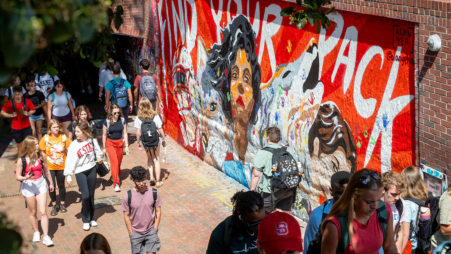 Students stroll past the 'Find Your Pack' mural at the Free Expression Tunnel in between classes on a September afternoon