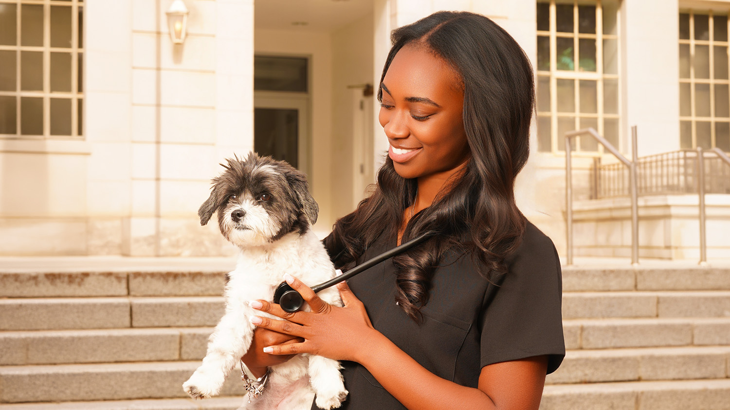 College of Agriculture and Life Sciences graduate Alexia Alexander with a cute puppy
