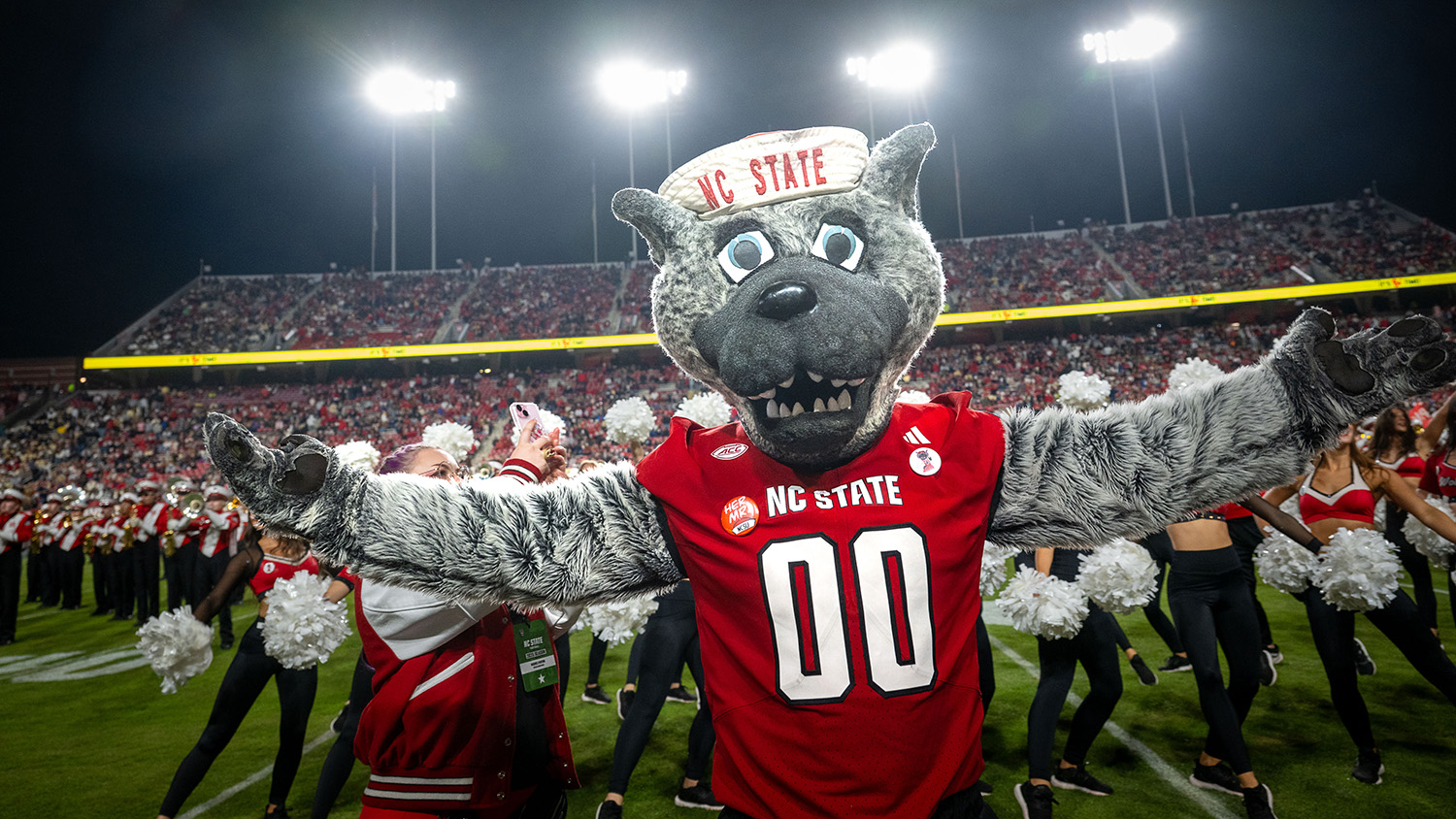 Mr. Wuf gets the crowd fired up at a football game at Carter Finley.